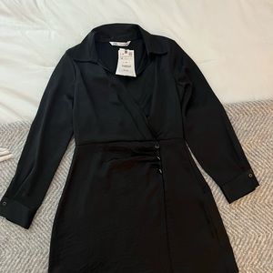 Black silk long sleeve mini dress.